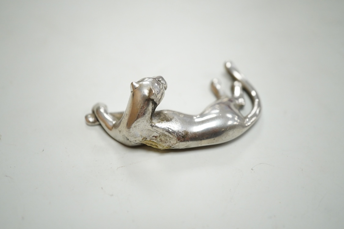 A recent Cartier paperweight, modelled as a recumbent 925 panther with blue glass sphere(a.f.), signed, in original fitted Cartier box, 56mm by 60mm.